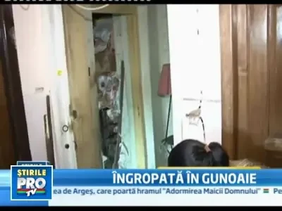 Ingropata in gunoaie, la propriu! A fost gasita fara viata in casa mizera