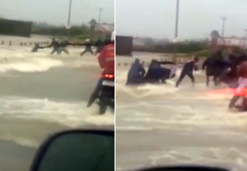 Mai multi oameni formeaza un "lant uman" pentru a salva un barbat de la inec, in India, unde inundatiile fac ravagii. VIDEO