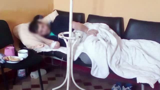 Pacient cu perfuzie, obligat sa stea pe un pat improvizat din scaune la spitalul din Medias. Explicatiile oferite de medici