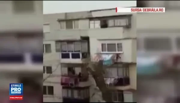 Un barbat din Braila pescuieste o pereche de pantaloni de la vecinul de jos. Scenele, filmate din blocul din fata