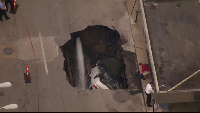 Masina, inghitita de un crater urias. A fost nevoie de o macara care sa o scoata la suprafata