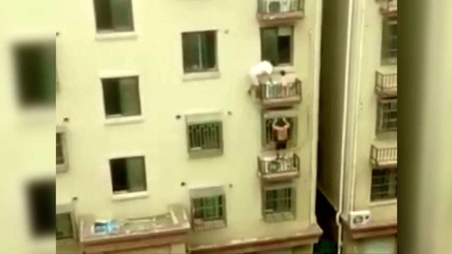 Momentul în care un copil agățat de balcon este salvat de doi bărbați care au escaladat clădirea