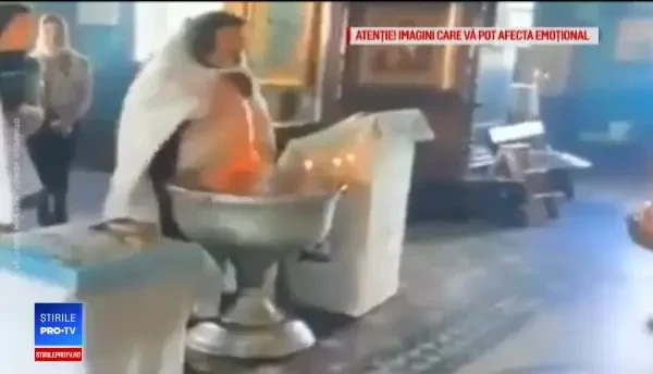 Reacția preotului care a brutalizat un bebeluș la botez, când o vede pe mama copilului